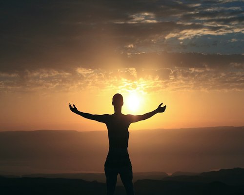 Woman stretching outdoors in morning sunlight